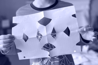 Child showing handmade snowflake