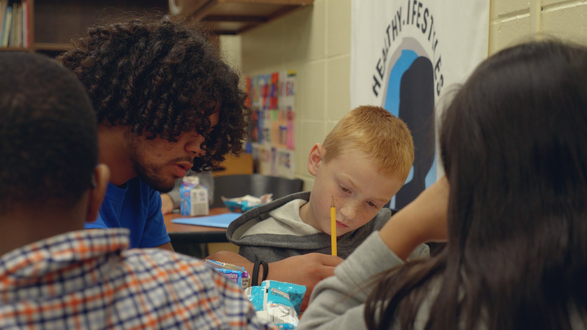 Boys and Girls Club mentor working with students after school.