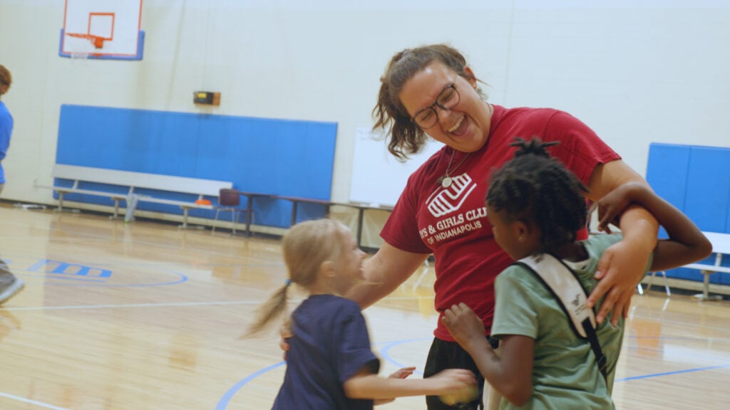 Boys and Girls Club mentor playing with kids.