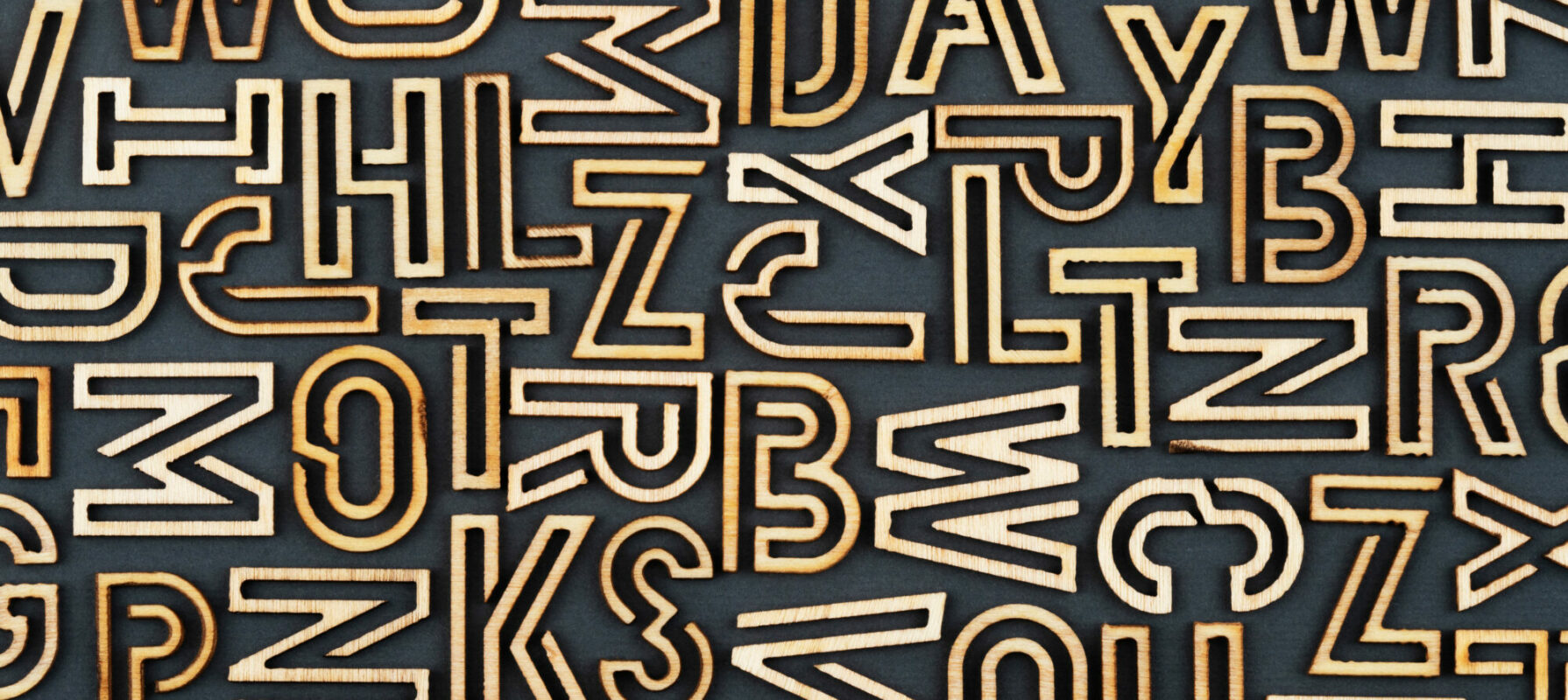 Gold letters on a black background, used to comment on AEO and the "alphabet soup" of marketing trends